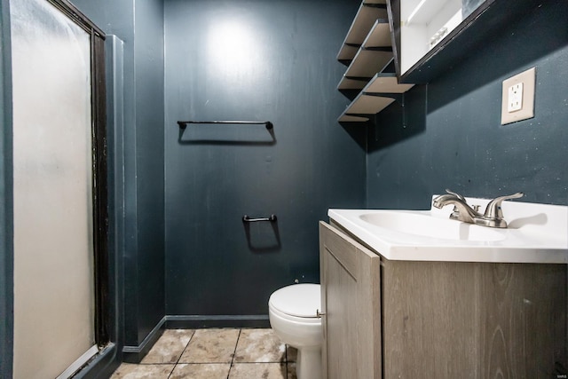 bathroom with tile patterned flooring, vanity, and toilet