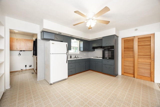 kitchen featuring white appliances, ceiling fan, gray cabinetry, and sink