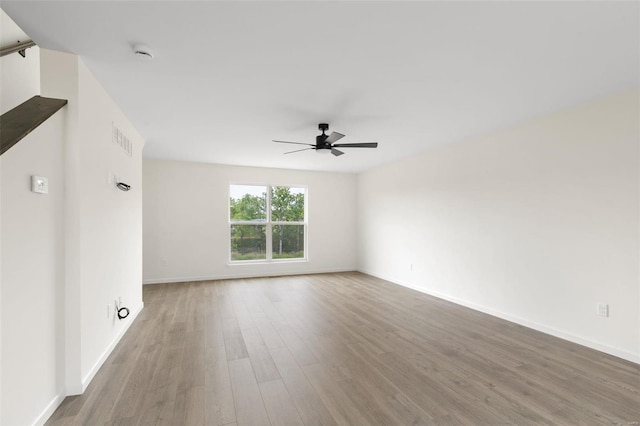 unfurnished room featuring ceiling fan and hardwood / wood-style floors