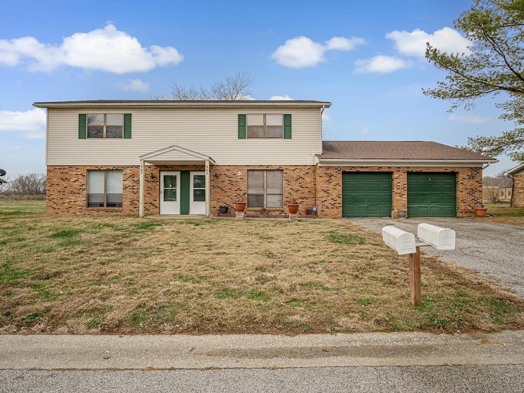 view of front facade featuring a front yard and a garage