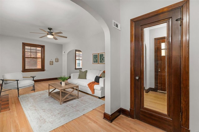 living room featuring ceiling fan, a healthy amount of sunlight, and light hardwood / wood-style floors