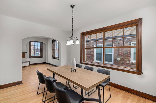 dining area featuring light hardwood / wood-style floors and a notable chandelier