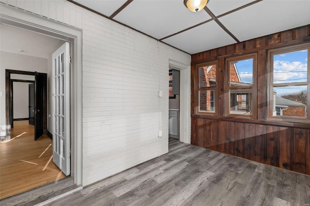 interior space with hardwood / wood-style flooring and wooden walls