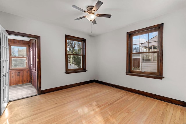 unfurnished room with ceiling fan, light hardwood / wood-style flooring, and a healthy amount of sunlight