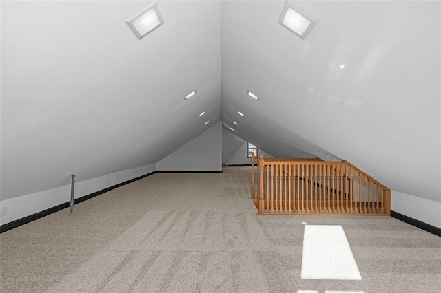 additional living space with light colored carpet and lofted ceiling