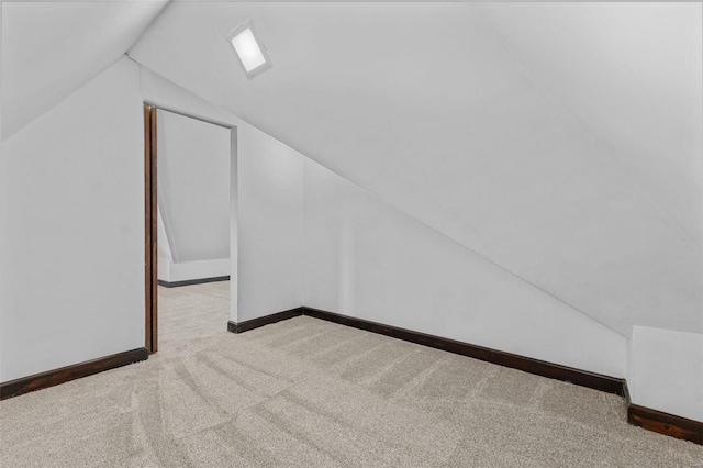 bonus room featuring light colored carpet and vaulted ceiling