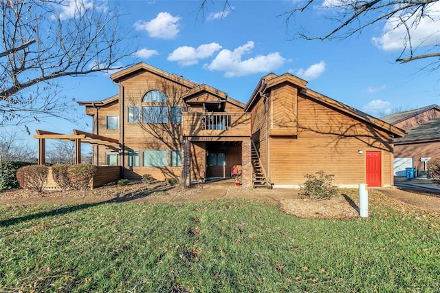 rear view of property featuring a yard and a balcony