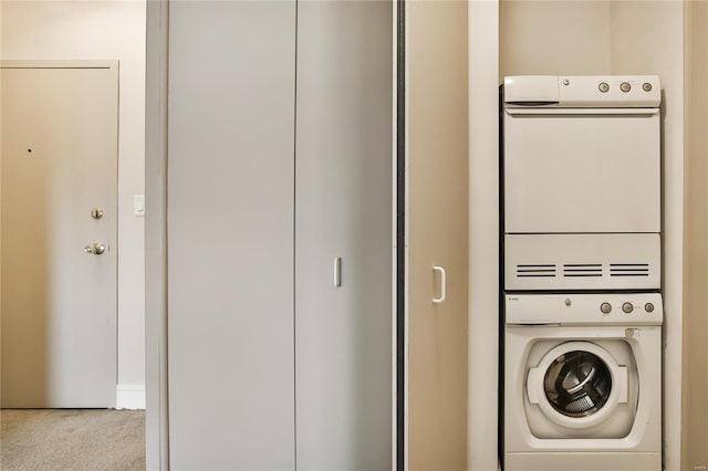 laundry area featuring light colored carpet and stacked washer and dryer