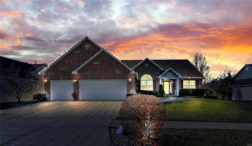 view of front facade with a garage and a lawn