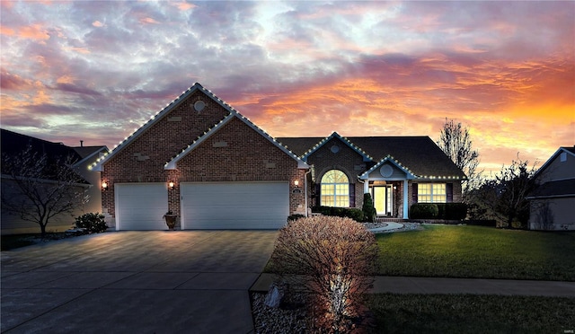 view of front facade with a garage and a lawn