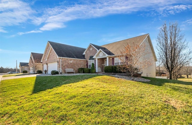 view of front of property featuring a front yard and a garage