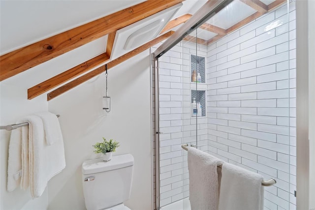 bathroom featuring toilet and a shower with door