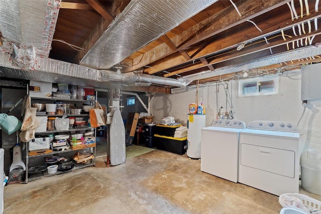 basement with washer and clothes dryer and water heater