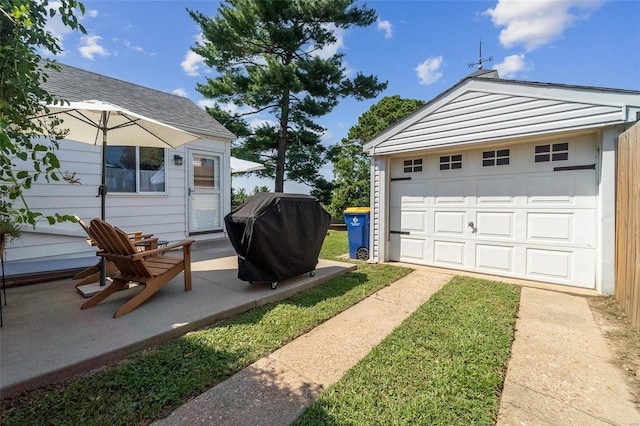 view of yard featuring a garage and an outbuilding