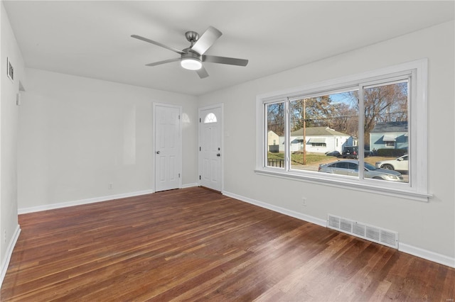 unfurnished room featuring ceiling fan and dark wood-type flooring