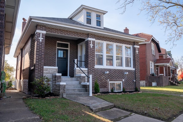 bungalow-style home featuring a front lawn