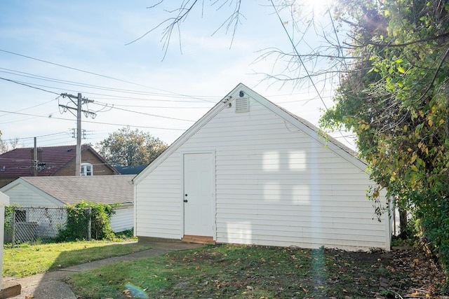 view of outbuilding with a yard