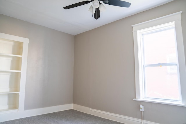 carpeted spare room with ceiling fan