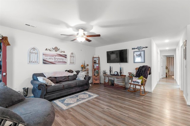 living room with ceiling fan and light hardwood / wood-style floors