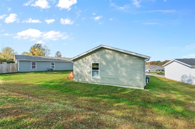 rear view of house featuring a yard