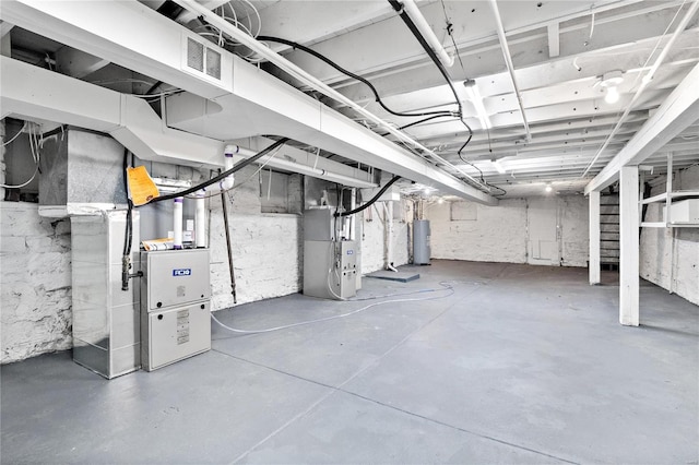 unfinished below grade area featuring heating unit, water heater, and visible vents