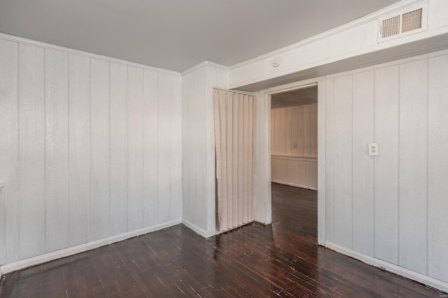 spare room with visible vents and hardwood / wood-style floors