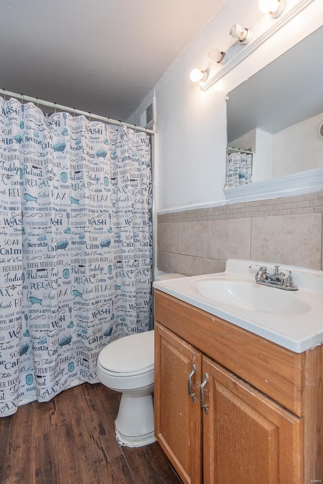 full bath with tile walls, toilet, vanity, wood finished floors, and a shower with curtain