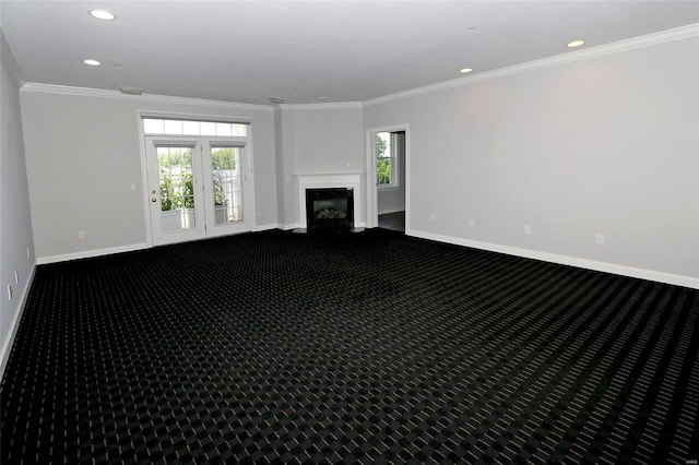 unfurnished living room with a fireplace, carpet, and ornamental molding