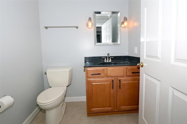 bathroom featuring tile patterned flooring, vanity, and toilet