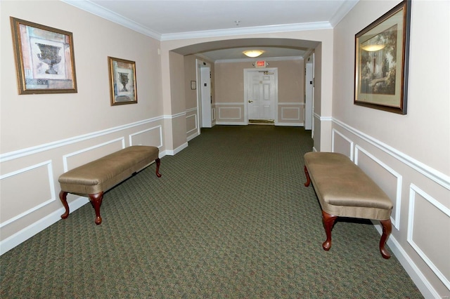 hall with crown molding and dark carpet