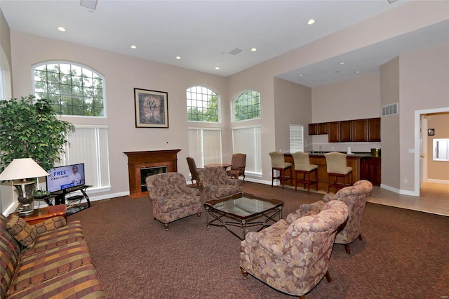 living room with carpet flooring and a high ceiling