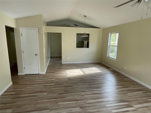 interior space featuring hardwood / wood-style flooring, ceiling fan, and lofted ceiling