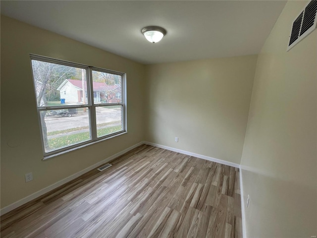 spare room featuring light wood-type flooring