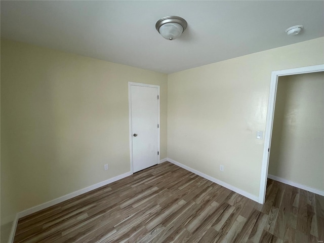 unfurnished room with wood-type flooring