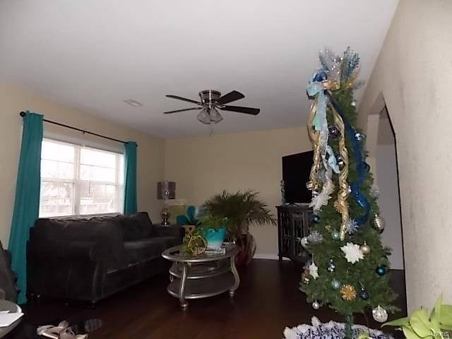 living room with ceiling fan and dark hardwood / wood-style flooring