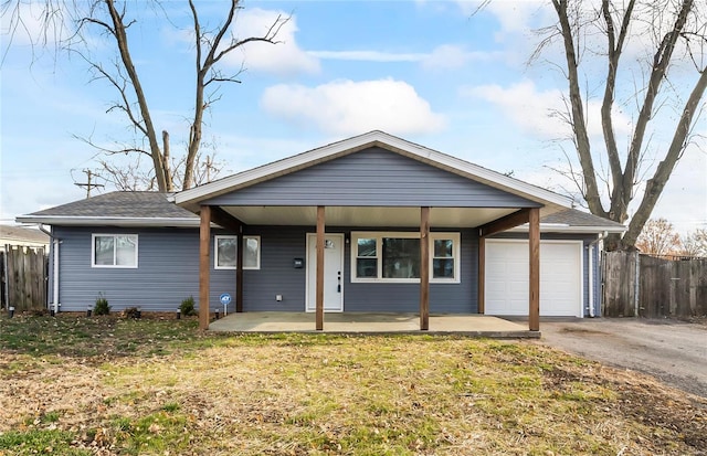 ranch-style house with a garage, a porch, and a front yard