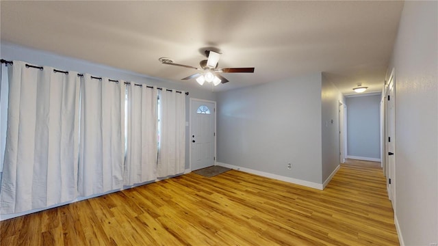 empty room with light hardwood / wood-style floors and ceiling fan