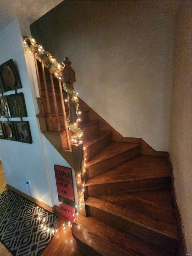 staircase with hardwood / wood-style flooring