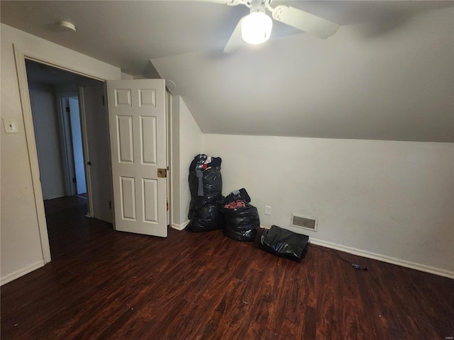 additional living space with ceiling fan, dark hardwood / wood-style flooring, and vaulted ceiling