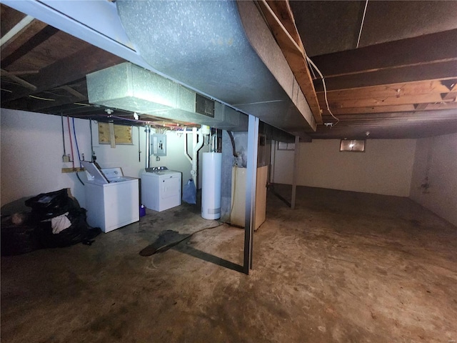 basement with water heater, washer and dryer, heating unit, and electric panel