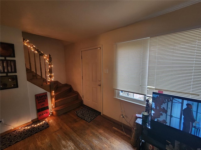 foyer featuring stairway, baseboards, and wood finished floors