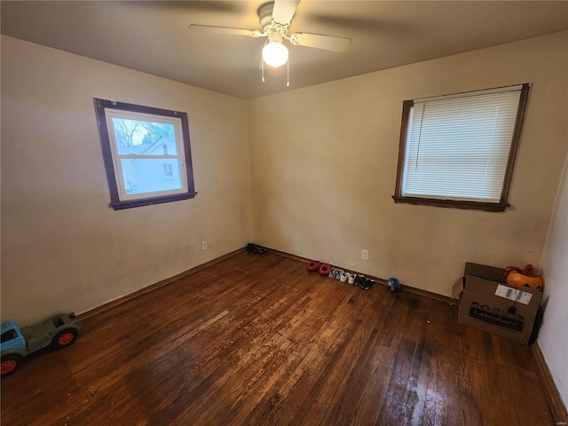 unfurnished room with dark wood-style floors and a ceiling fan