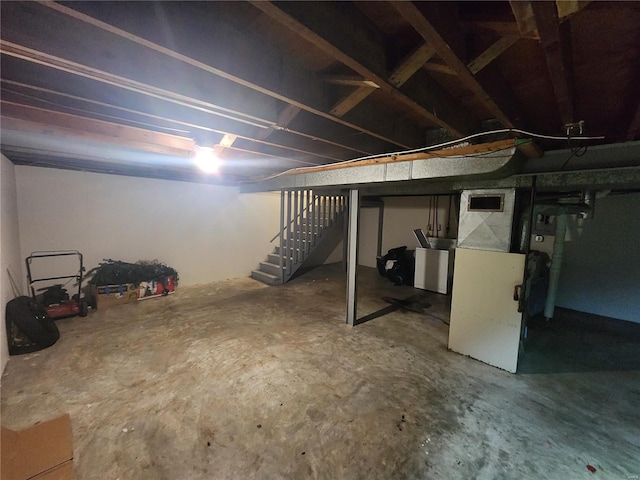 unfinished basement with stairway and heating unit