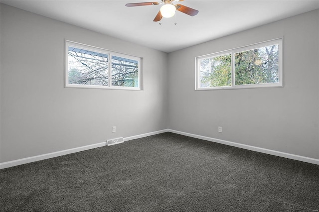 carpeted empty room with plenty of natural light and ceiling fan