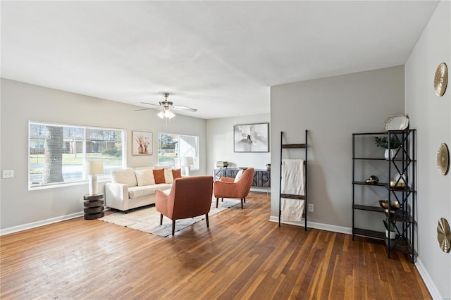 living room with ceiling fan and dark wood-type flooring