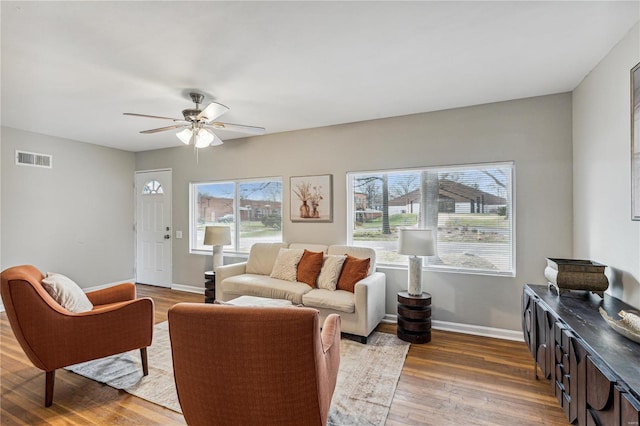 living room featuring dark hardwood / wood-style floors and ceiling fan