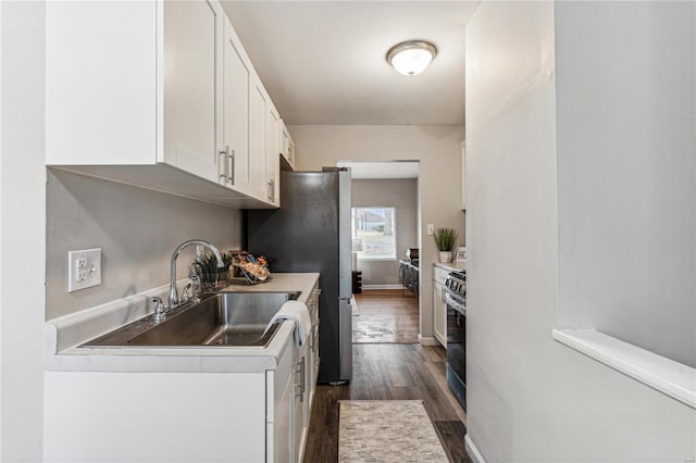 kitchen featuring sink, white cabinetry, dark wood-type flooring, and appliances with stainless steel finishes