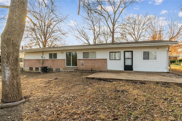 rear view of house featuring central AC unit and a patio area