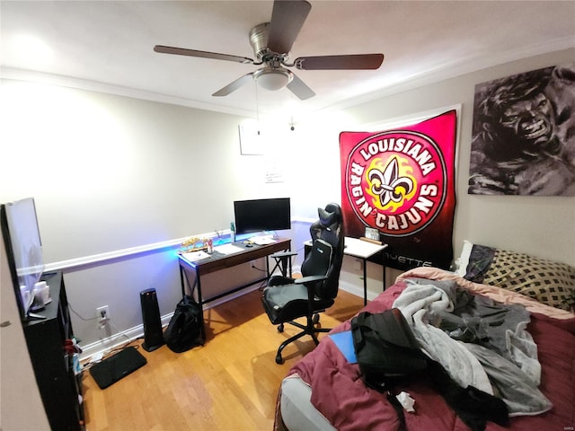 office with ornamental molding, wood finished floors, a ceiling fan, and baseboards