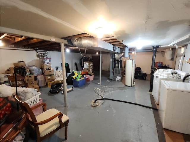 unfinished below grade area featuring water heater, washing machine and dryer, and heating unit